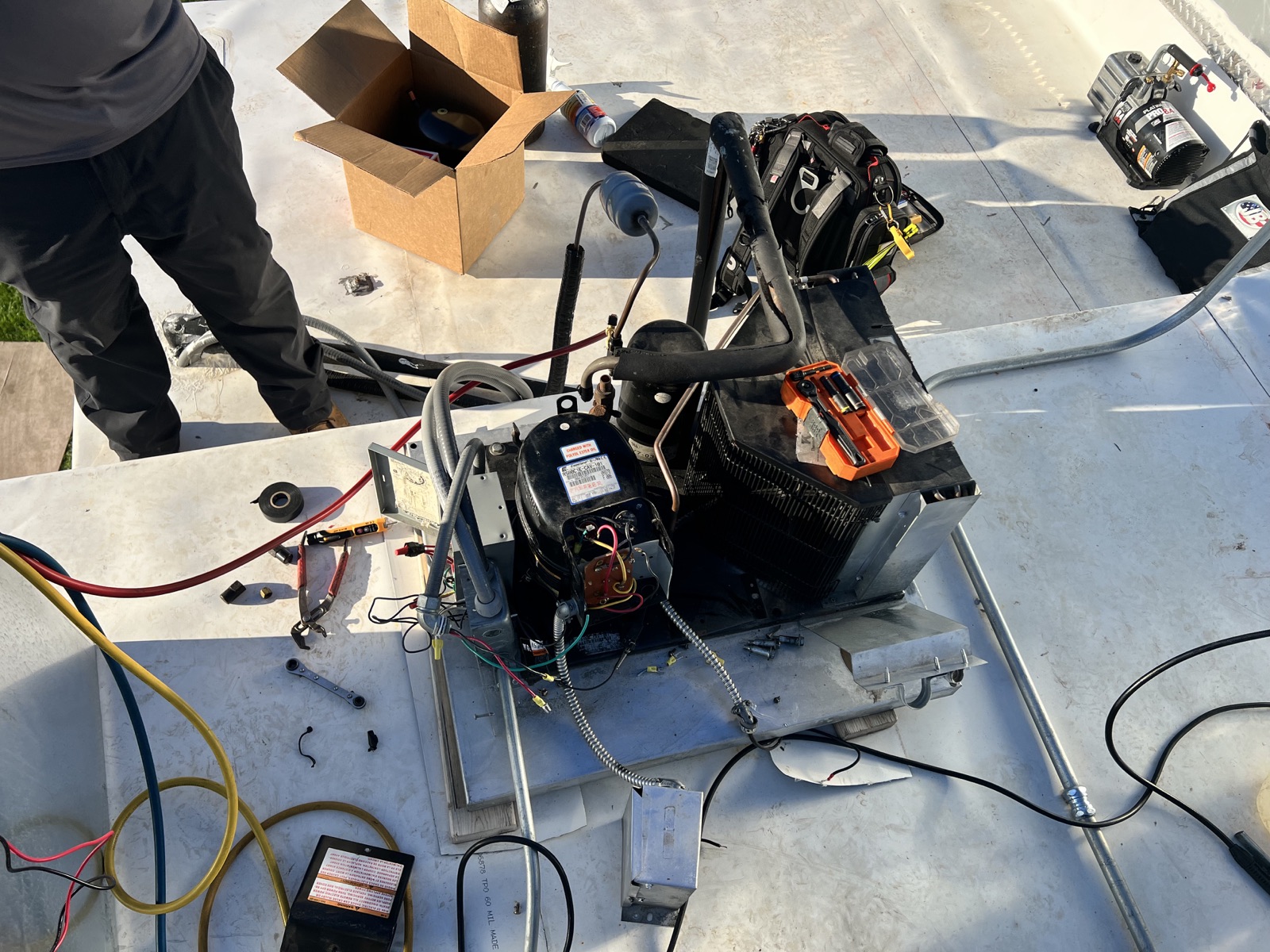 Technician repairing walk-in cooler equipment